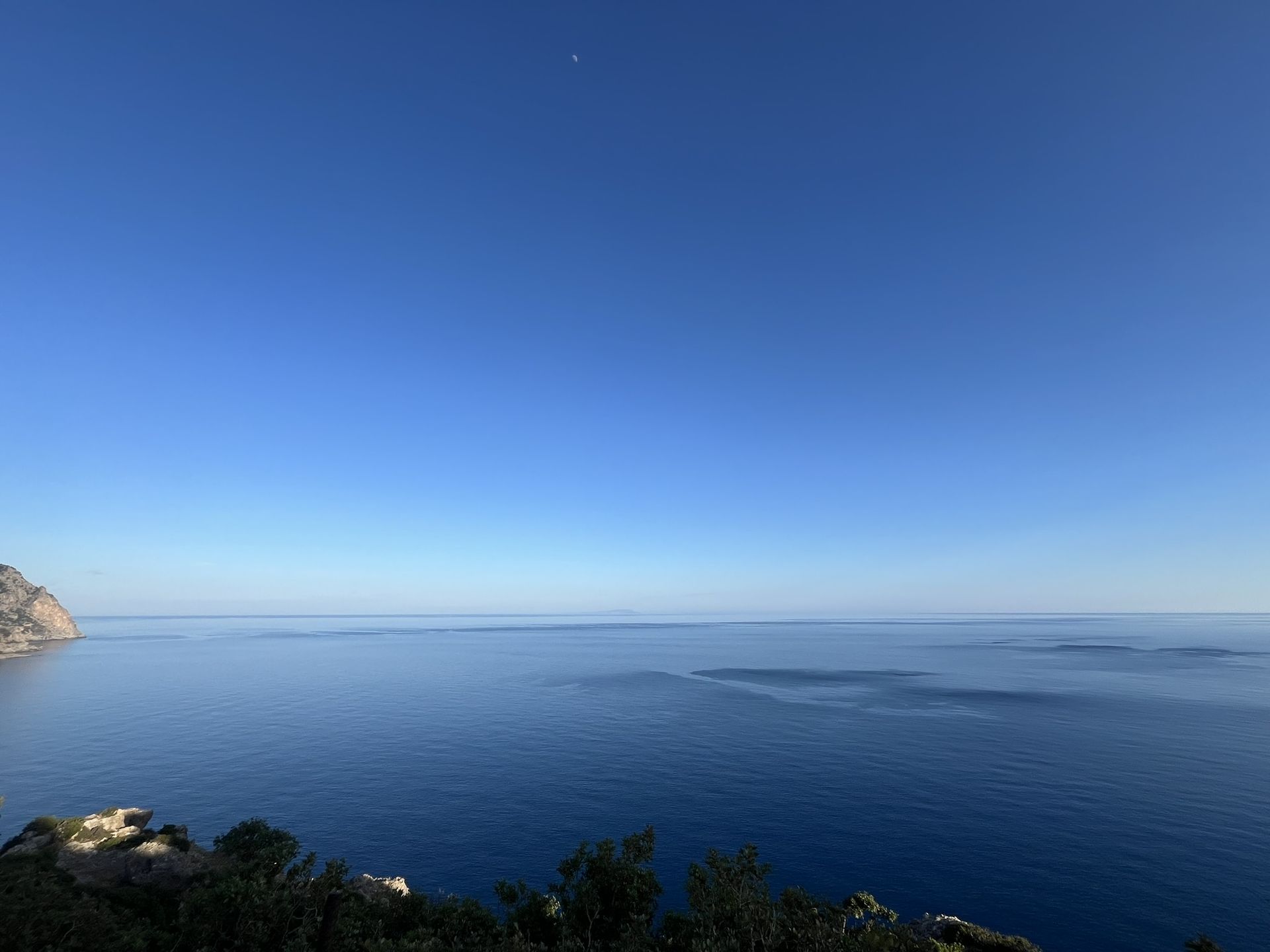 A calm deep-blue sea to the horizon