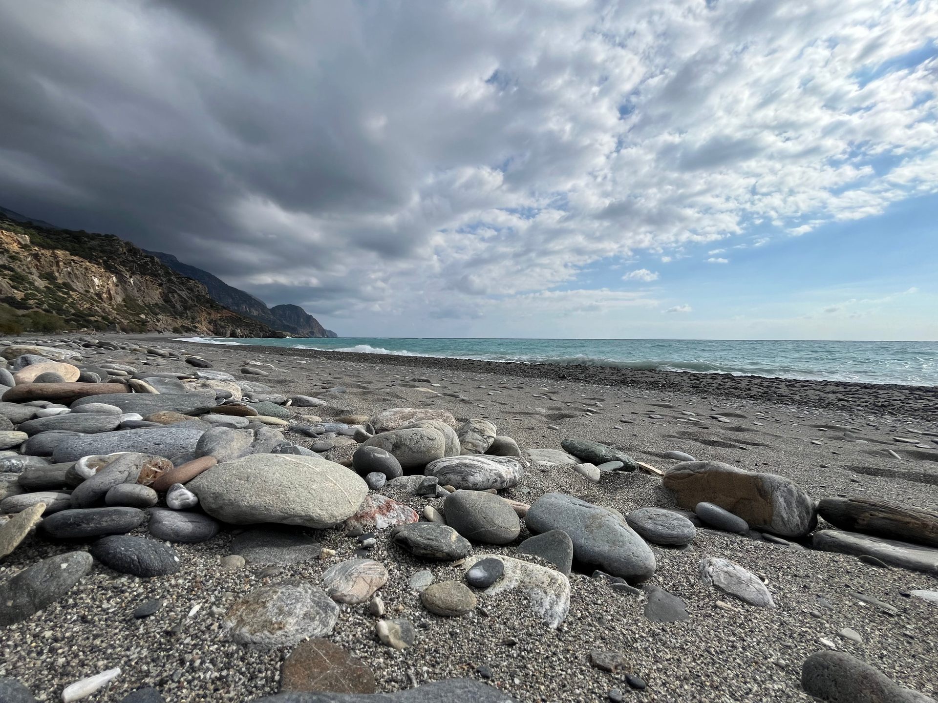 Storm clouds rolling over the stones of the beach