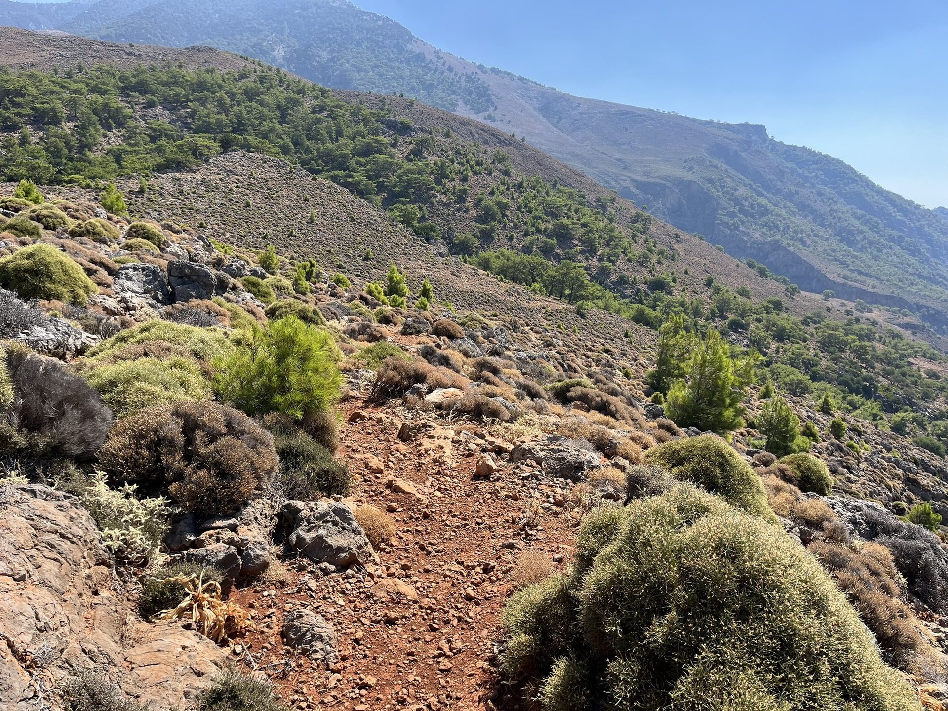 The red earth path across the mountainside towards the Cyclops cave