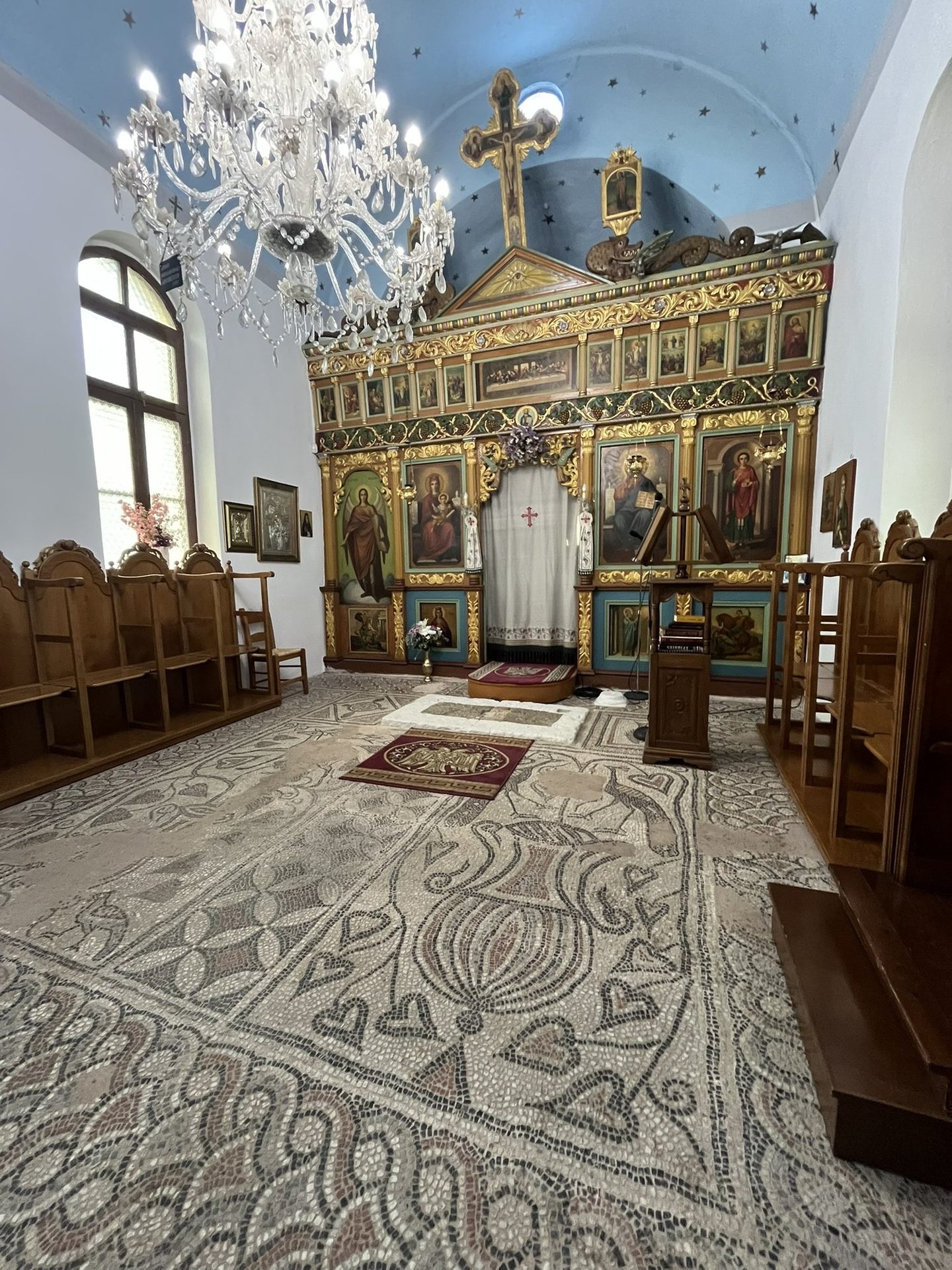 The mosaic floor of the church of Saint Panteleimon in Sougia, with the iconostasis behind