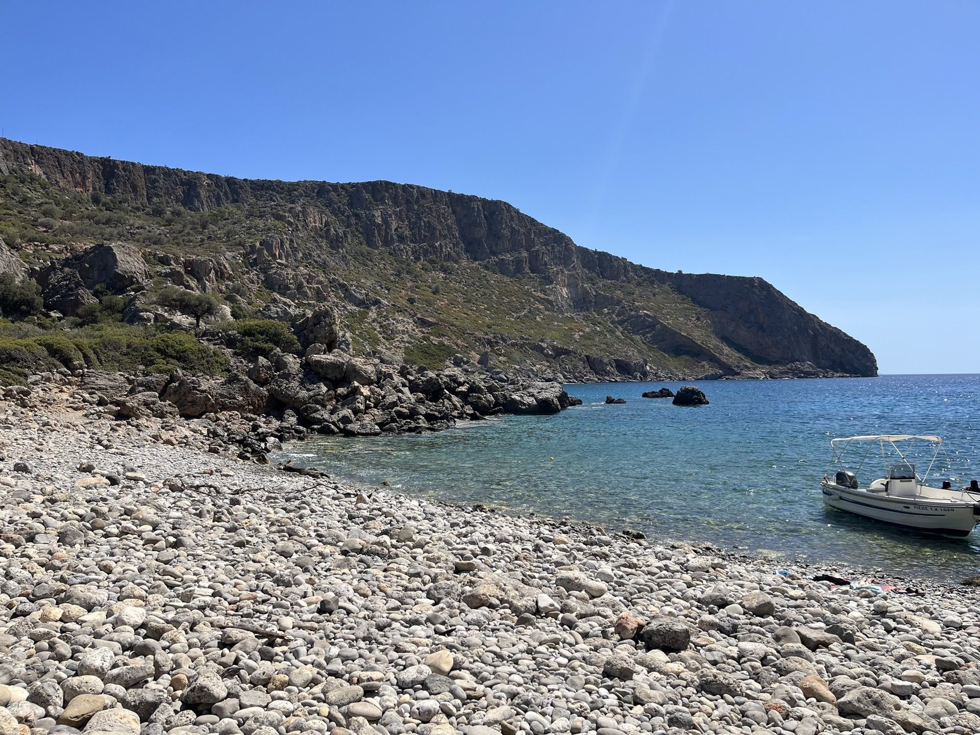 A small boat at the pebble beach of Lissos