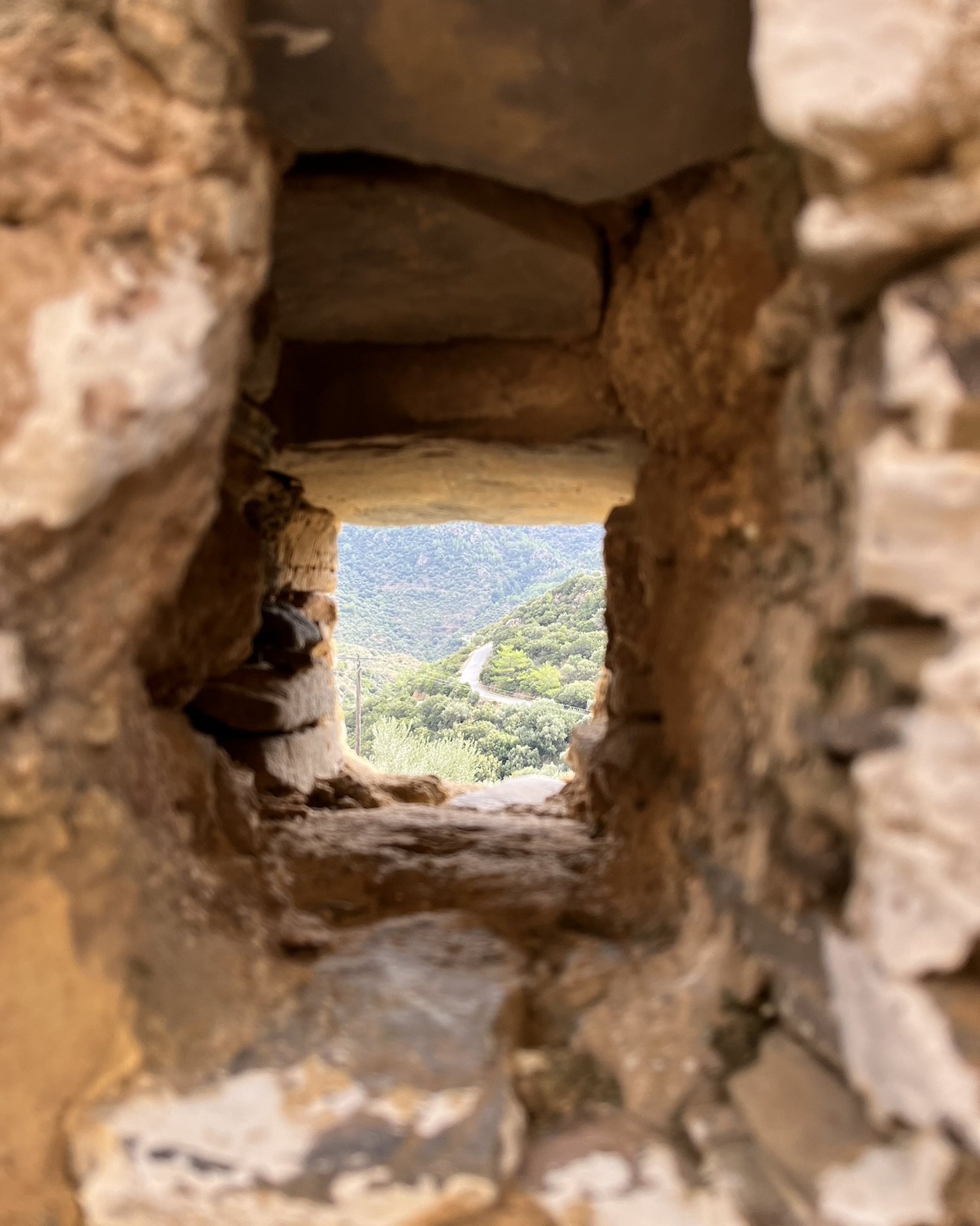 The road down to Sougia seen through a small opening in the bell tower wall