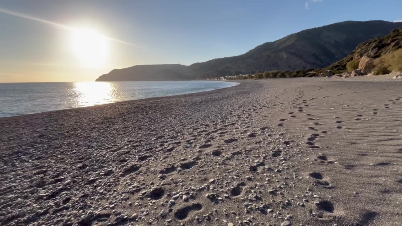 Low golden sun over the beach of Sougia