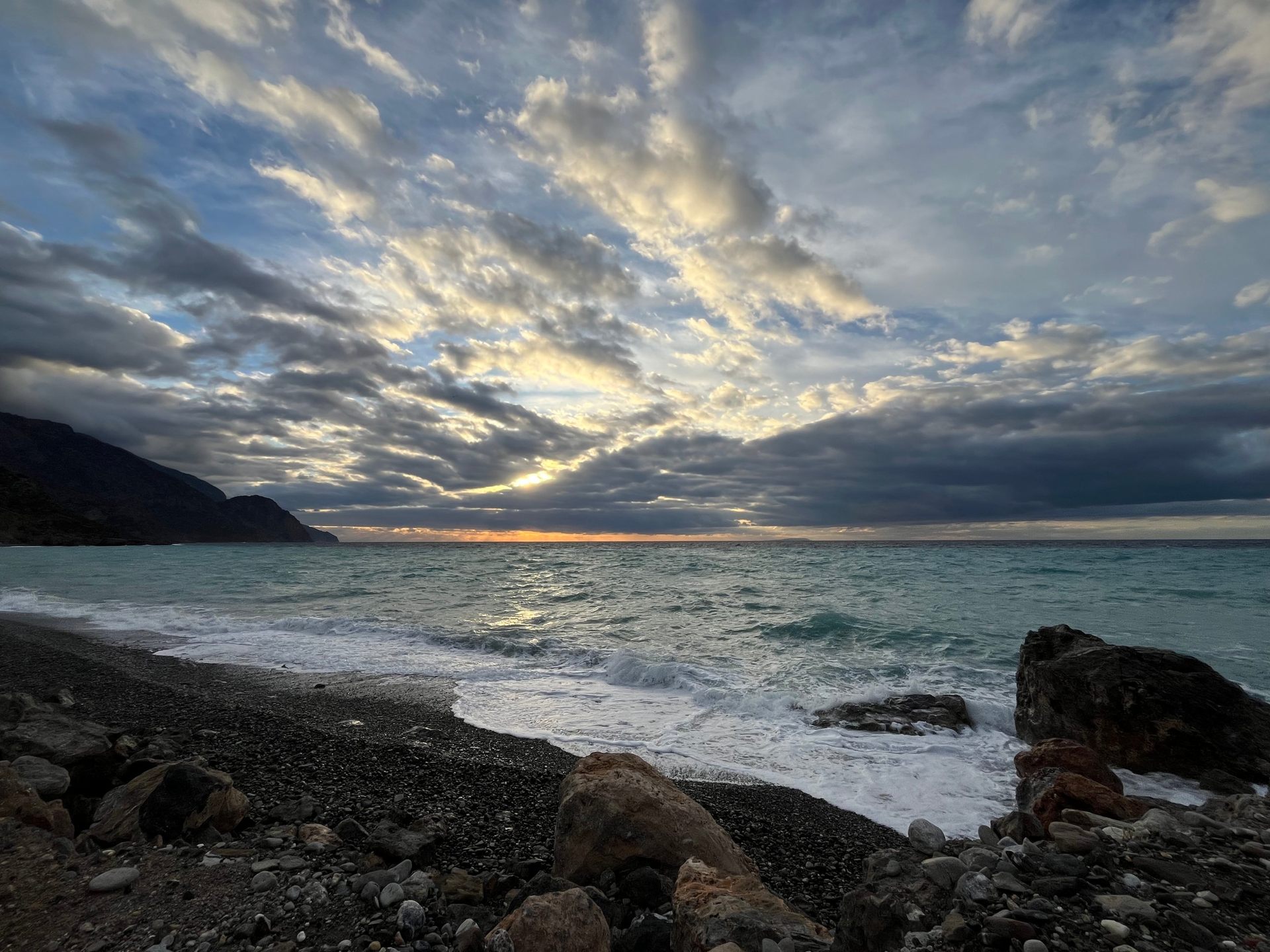 Wind-driven clouds and waves on the beach