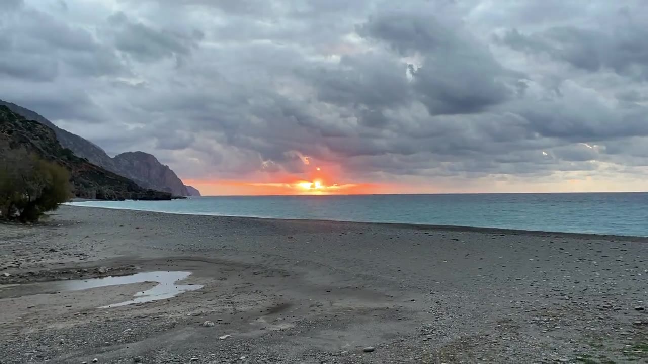 First light under winter clouds over the beach